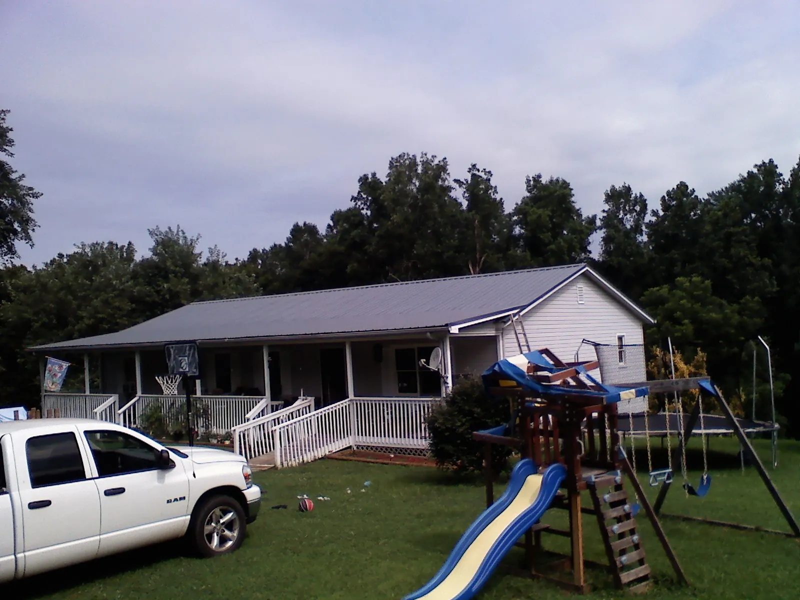 Dark metal roof on a country home with a full length front porch in Bethesda